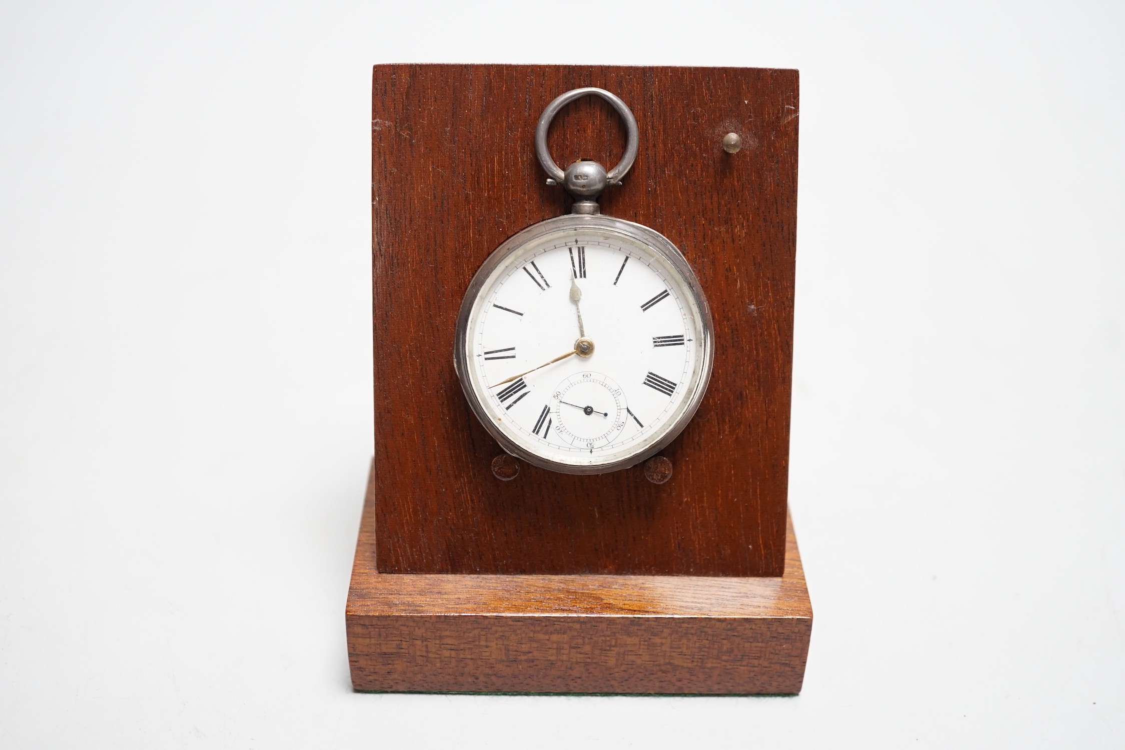 A silver pocket watch and holder